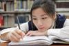 Photo of a teenage student doing their homework.