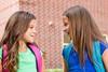 two girls talking outside school