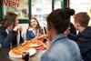Group of teenagers eating pizza