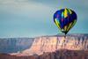 Hot-air ballon flying over canyon