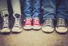 Kids feet wearing sneakers lined up