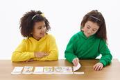 Photo of children playing a   card game.