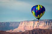 Hot-air ballon flying over canyon