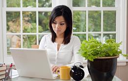 Photo of a person typing on their laptop.