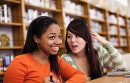 Photo of students talking to each other.