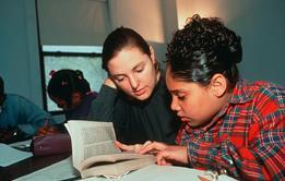 Photo of students using a dictionary or simply a photo of a dictionary.