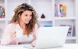 Photo of a teacher reading, an article or something online.