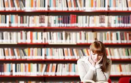 Photo of students reading in a classroom or in a library.