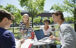 four young adults talking