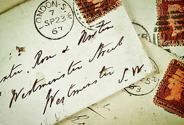 A person buying a card at a shop or of a card and its envelope with a stamp and address