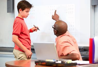 Teacher explaining something to a student