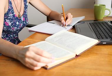 Photo of someone working on different versions of the same text, to show the different stages of the writing process.