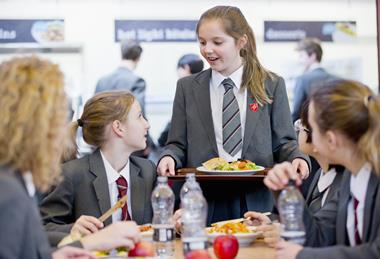 School girls talking in cafeteria