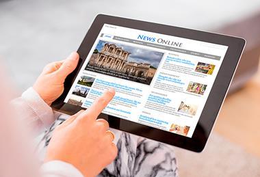 Photo of a person reading a newspaper or reading online news.