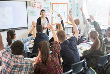 Photo of a teacher and her students (teenagers).