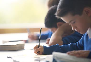 Ideally, photo of a child/ children using a dictionary. If too hard, photo of children in a classroom interacting with their teacher.