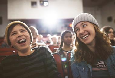 Two teenagers laughing together