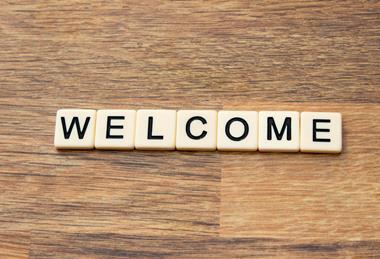 Word WELCOME formed with Scrabble tiles