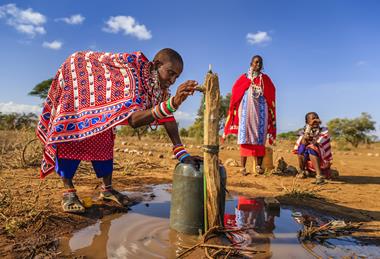 African woman getting water from well