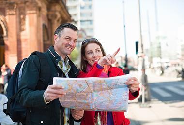 Couple of tourists looking at map