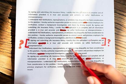Photo of a sheet of paper with mark-up, e.g.: red corrections.