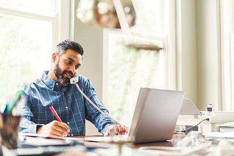 Photo of a business professional writing or typing on a computer.