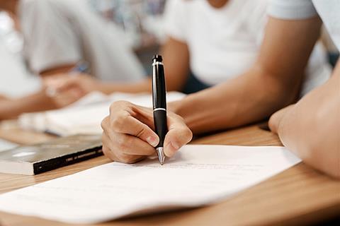 Photo of a person or a group of people taking a written test.