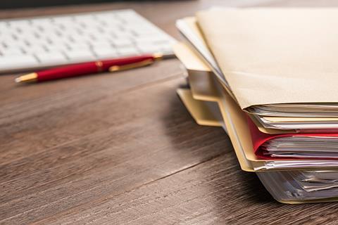 Photo of a person sorting out files, to suggest the idea of a portfolio. If too hard, photo of folders and files, in a pile for example.