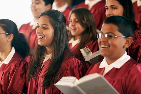 Photo of teenage students singing a song. If too hard, photo of a CD player, or just CDs,  and books to suggest the idea of learning through music.