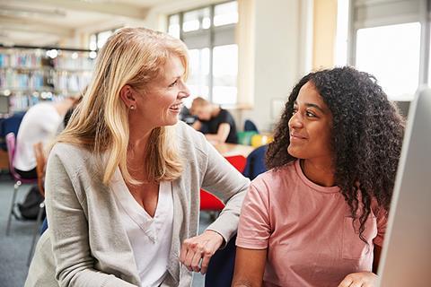 Photo of a teacher speaking to their students.