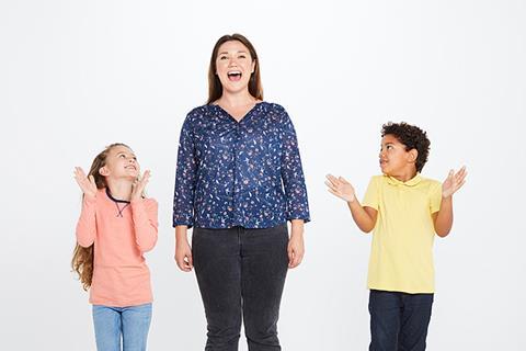 Phot of children in a classroom singing.