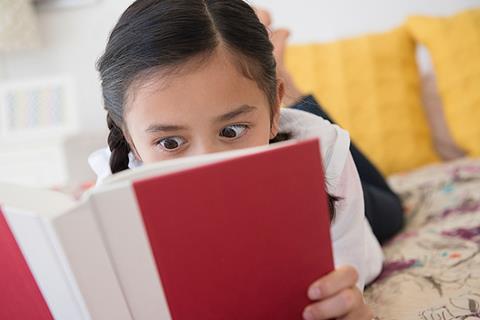 Photo of children reading in the  classroom or at home.