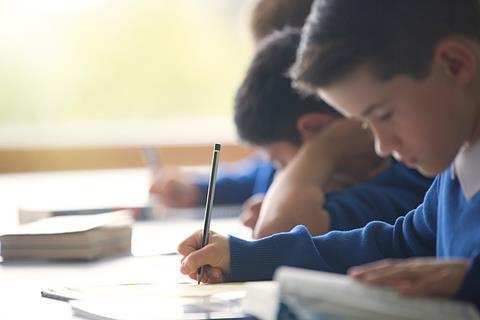 Ideally, photo of a child/ children using a dictionary. If too hard, photo of children in a classroom interacting with their teacher.