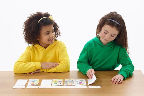 Photo of children playing a   card game.