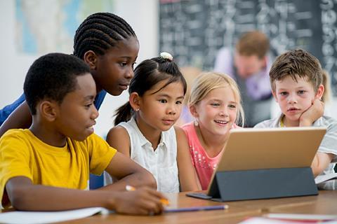 Photo of children watching a video in the classroom.