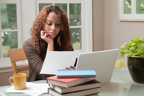 Photo of a teacher preparing a class, ideally with a laptop and a headset.