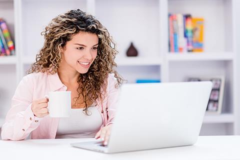 Photo of a teacher reading, an article or something online.