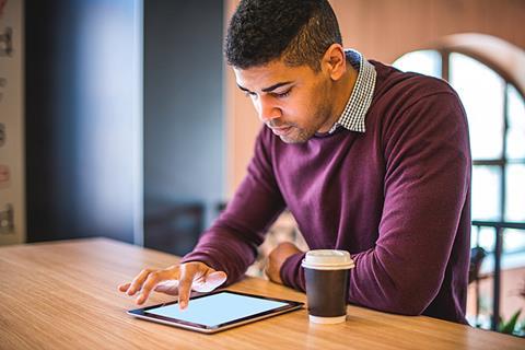 Photo of a teacher reading an article or a book.