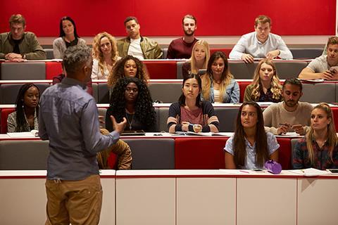 Photo of a teacher talking to their students.