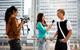 Photo of an interview on the street where the interviewer and interviewee are from different cultures