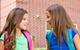 two girls talking outside school