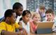 Photo of children watching a video in the classroom.