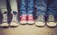 Kids feet wearing sneakers lined up